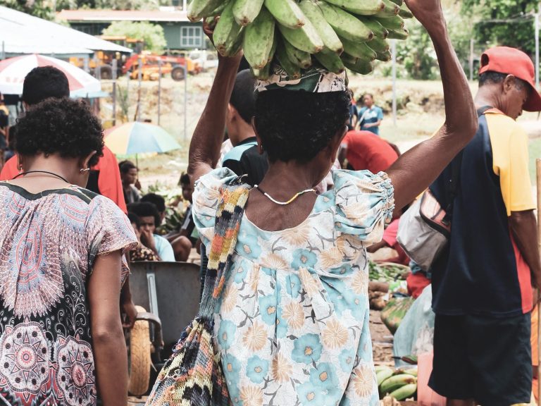 Woman carrying bananas on her head