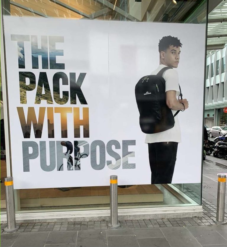 outdoor advertisement featuring a person with a backpack
