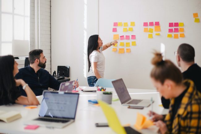 jason-goodman-Oalh2MojUuk-unsplash Image of a group idea generating with post it notes and laptops
